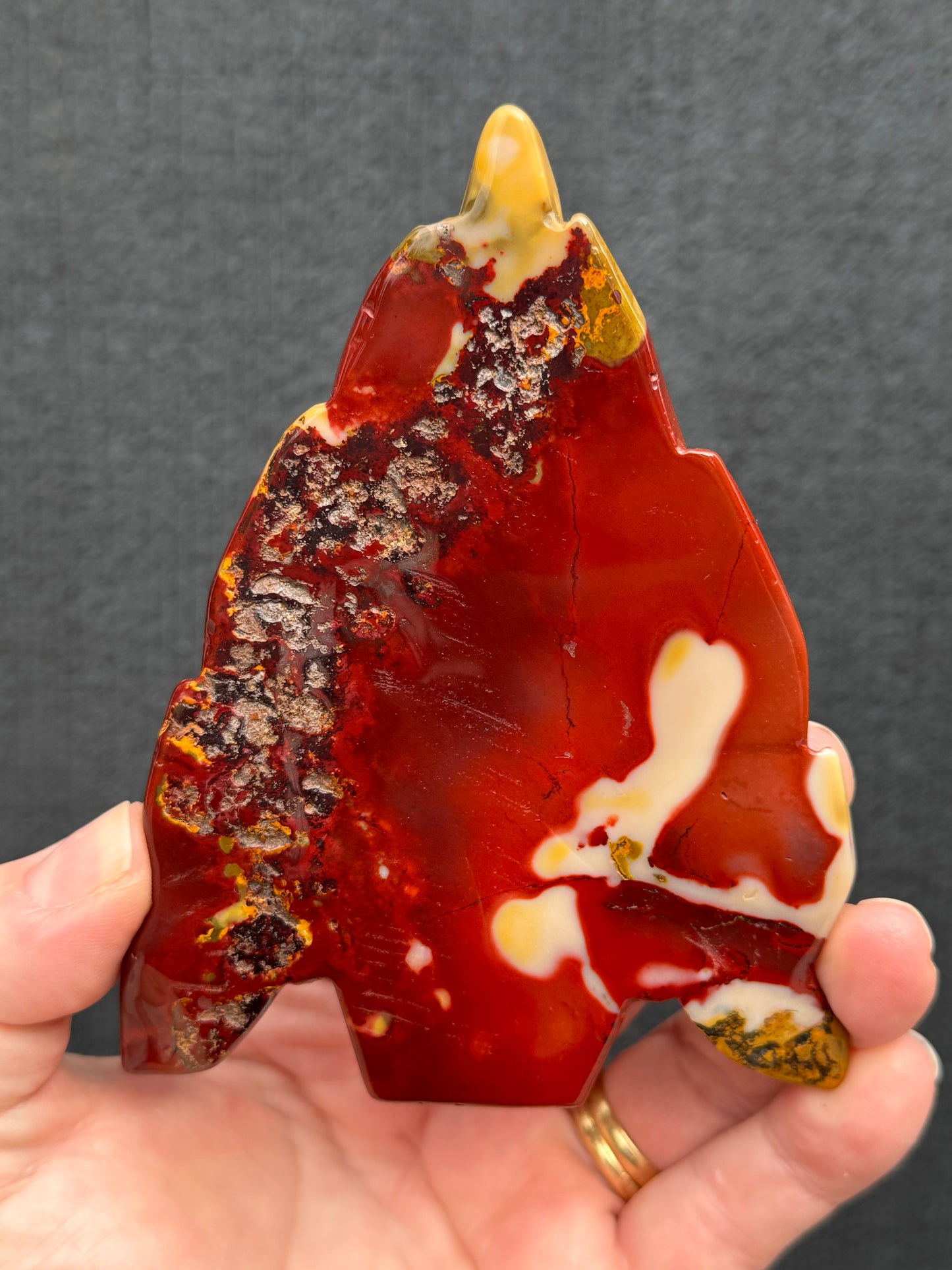 Mookaite Jasper carved Skull with Feathers on a stand