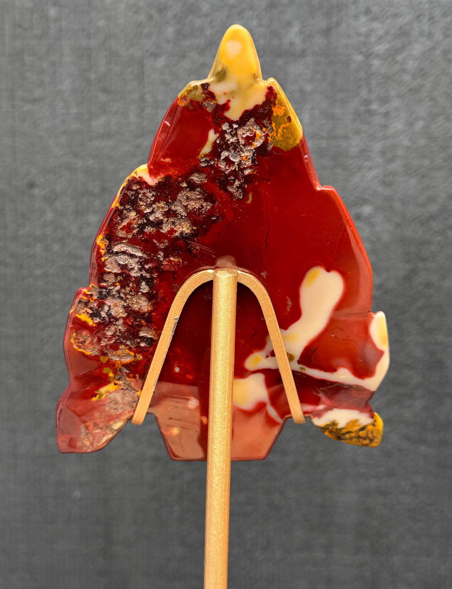 Mookaite Jasper carved Skull with Feathers on a stand