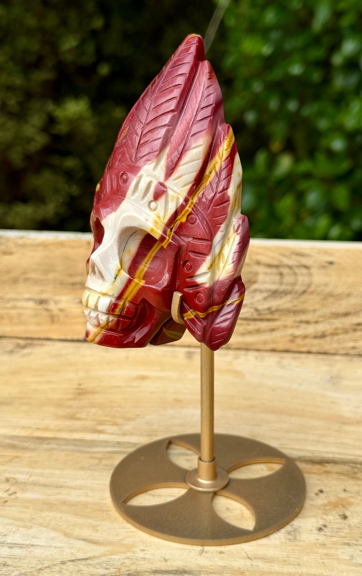 Mookaite Jasper carved Skull with Feathers on a stand