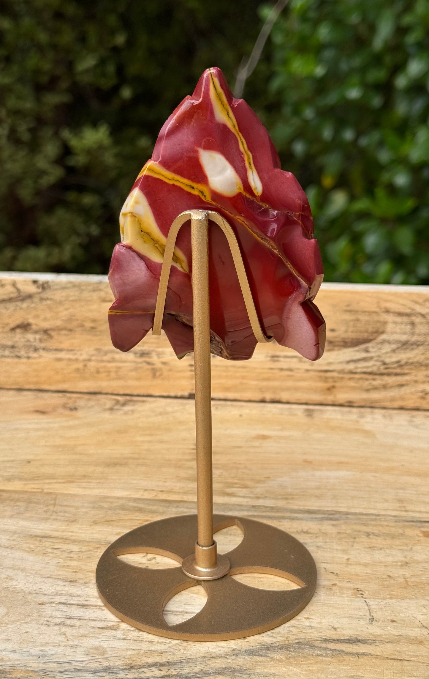 Mookaite Jasper carved Skull with Feathers on a stand