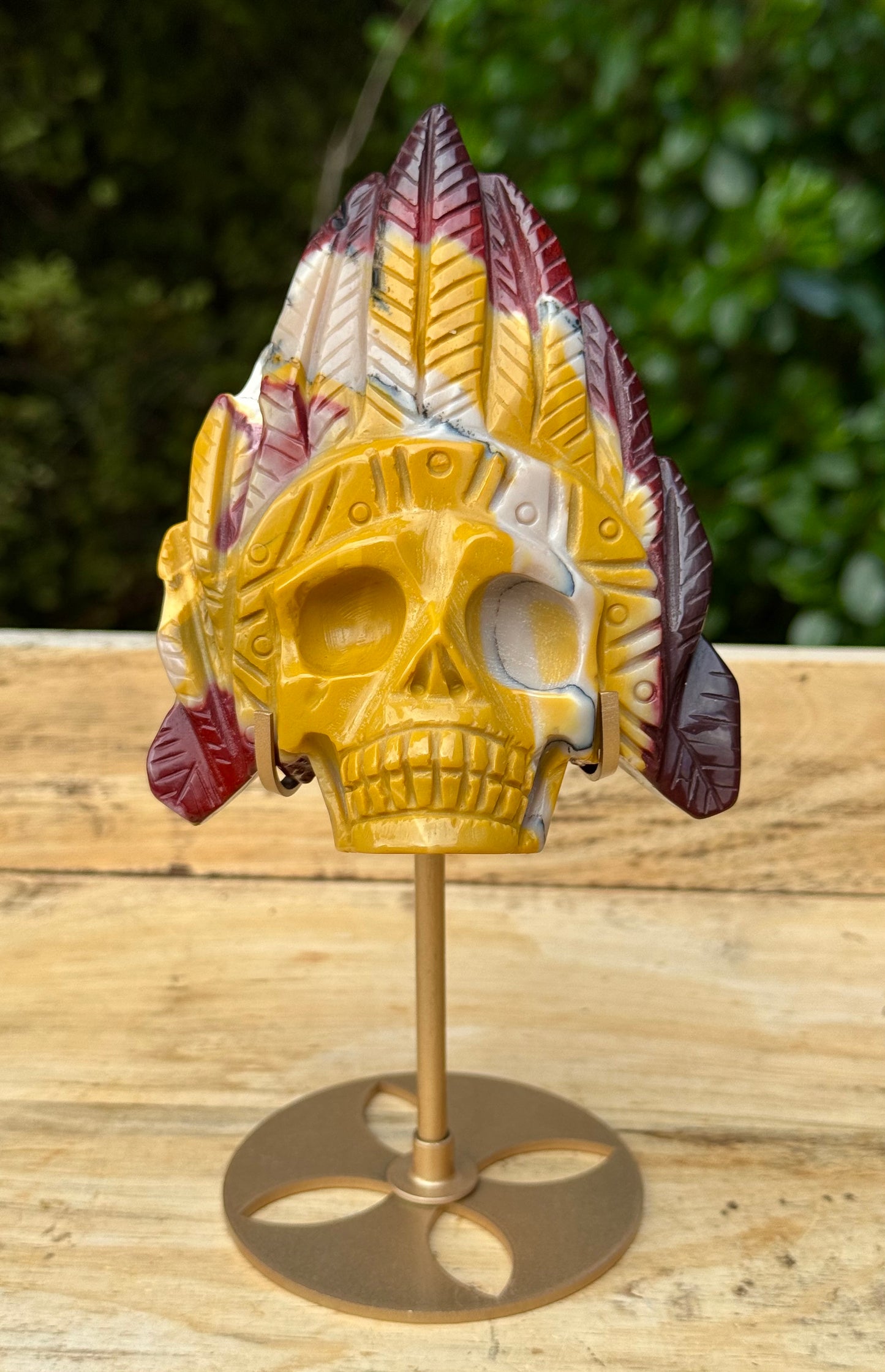 Mookaite Jasper carved Skull with Feathers on a stand