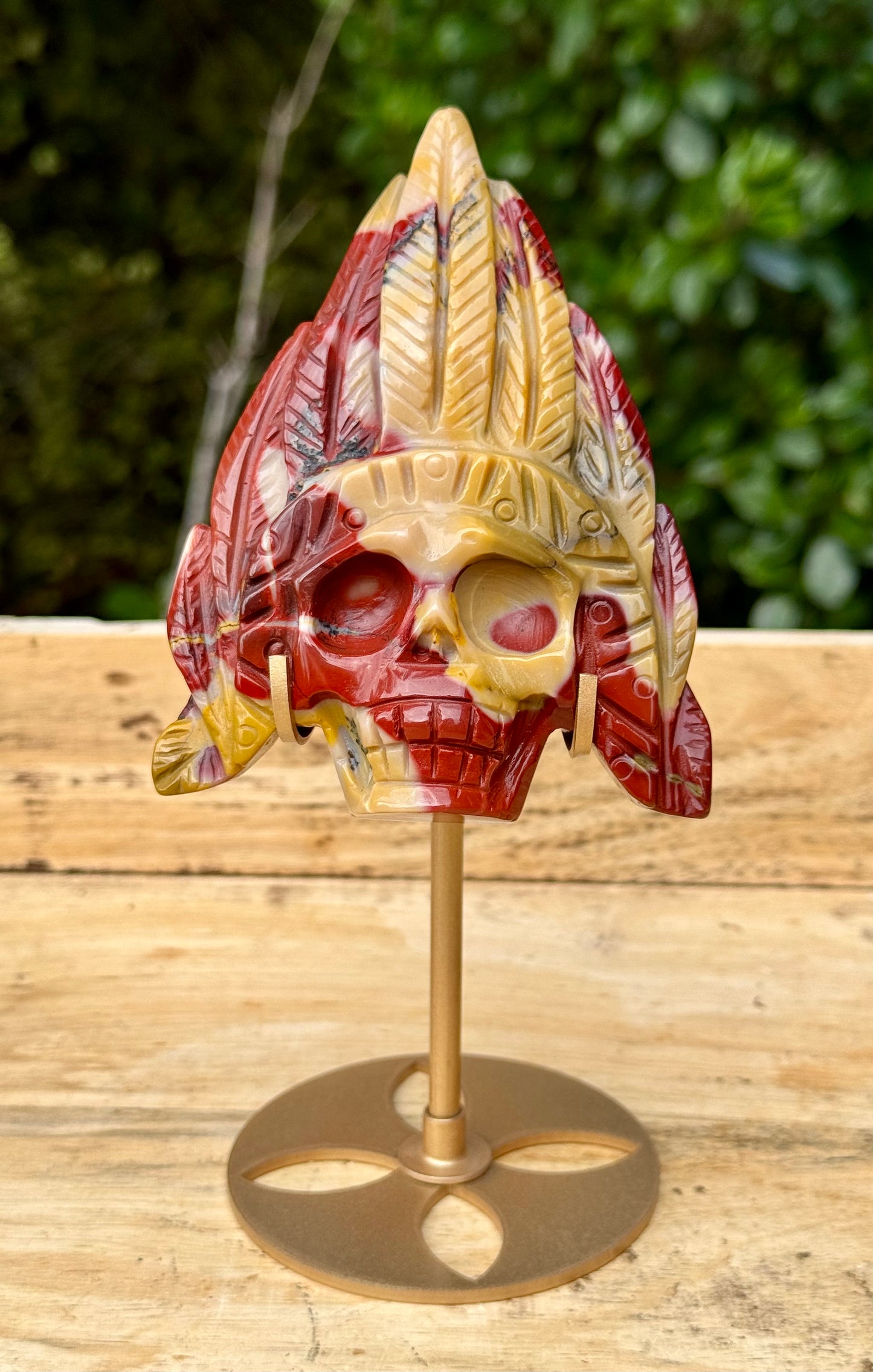 Mookaite Jasper carved Skull with Feathers on a stand