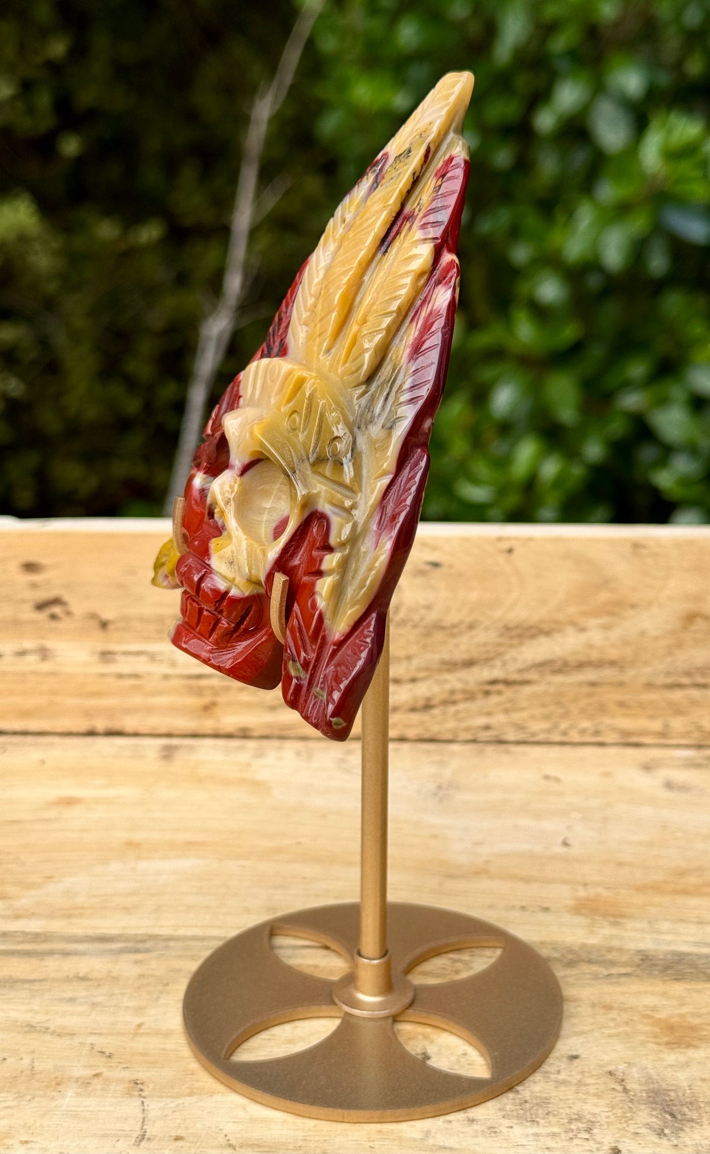 Mookaite Jasper carved Skull with Feathers on a stand