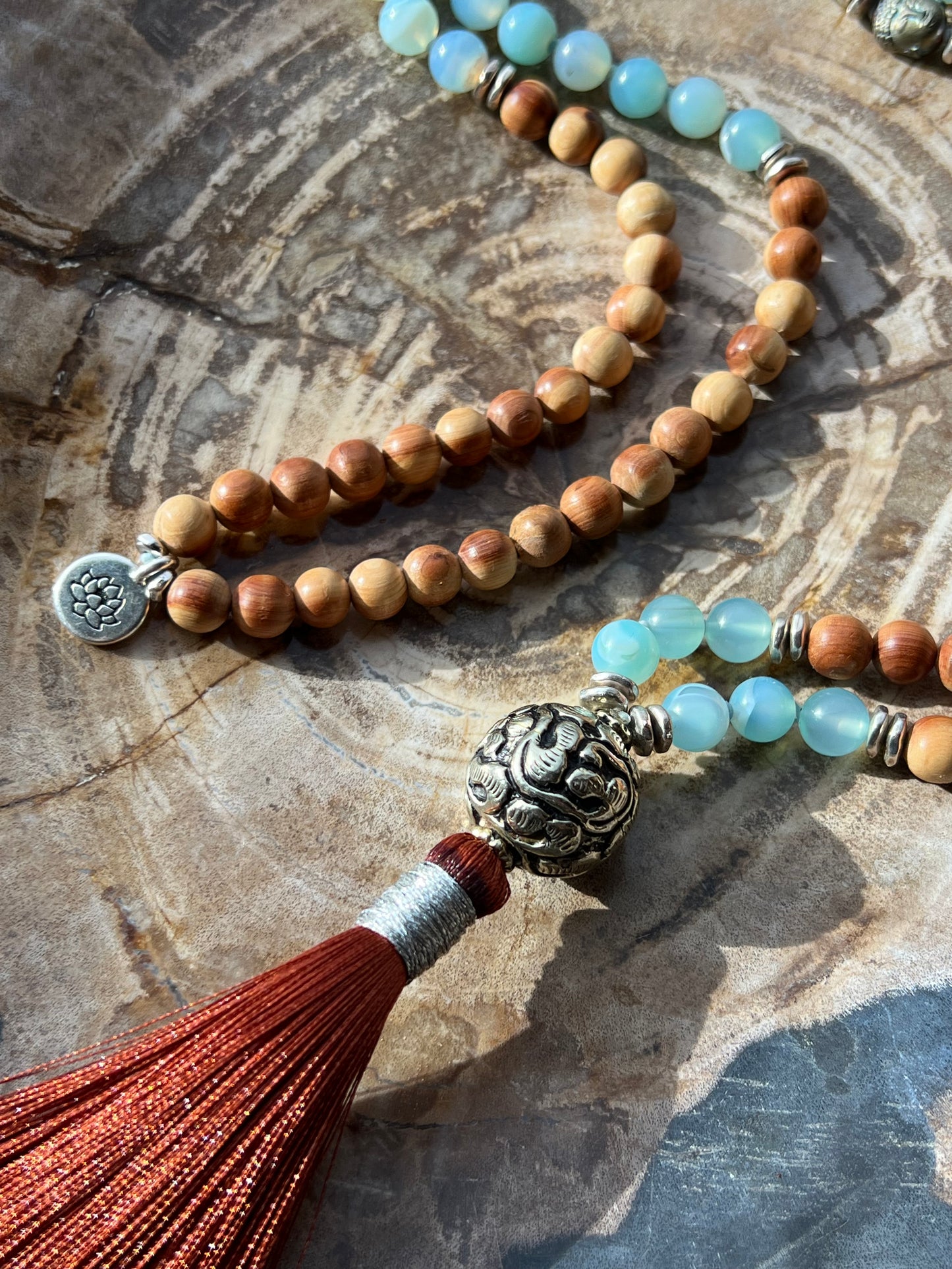Mālā with Lake Blue Agate and Pearwood Beads with a Nepalese Silver Guru Bead, and a silky Tassel