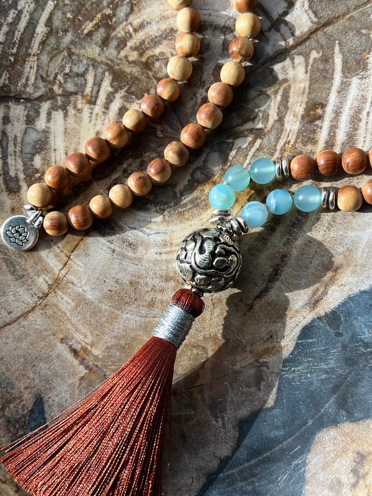 Mālā with Lake Blue Agate and Pearwood Beads with a Nepalese Silver Guru Bead, and a silky Tassel