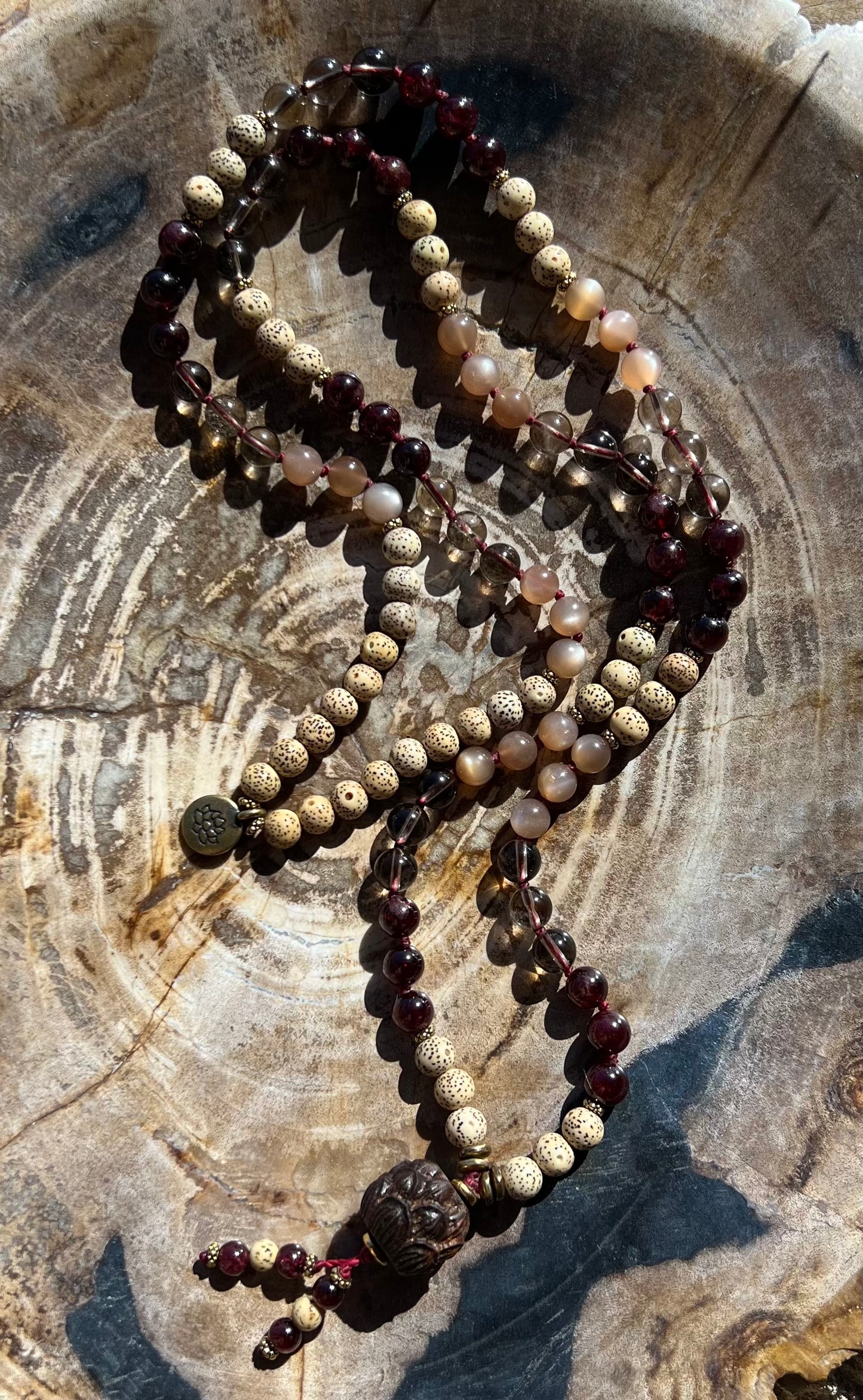 Mālā with Garnet, Smoky Quartz, Sunstone and Lotus Seed Beads with a Carved Lotus Guru Bead/ Pendant