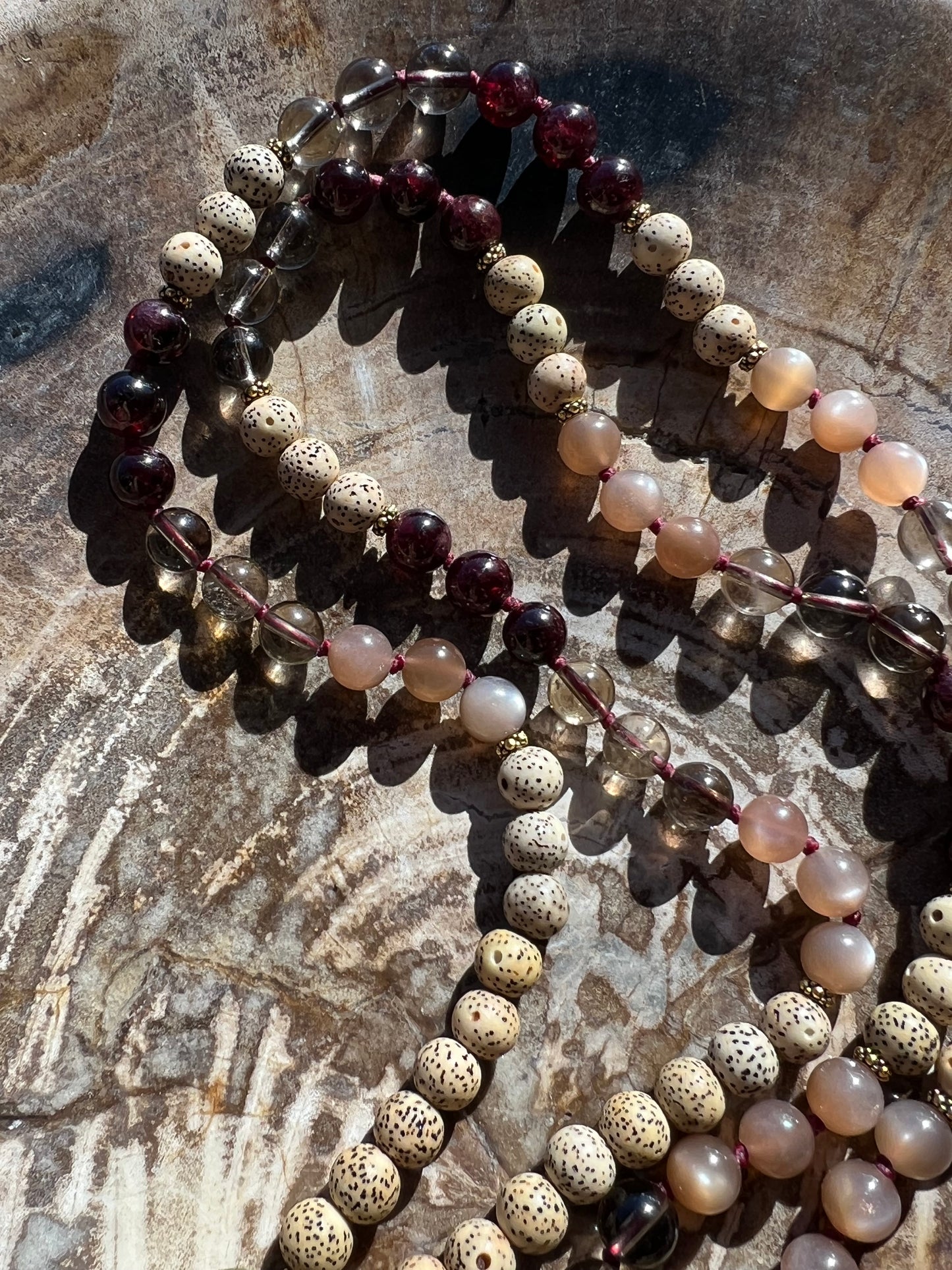 Mālā with Garnet, Smoky Quartz, Sunstone and Lotus Seed Beads with a Carved Lotus Guru Bead/ Pendant