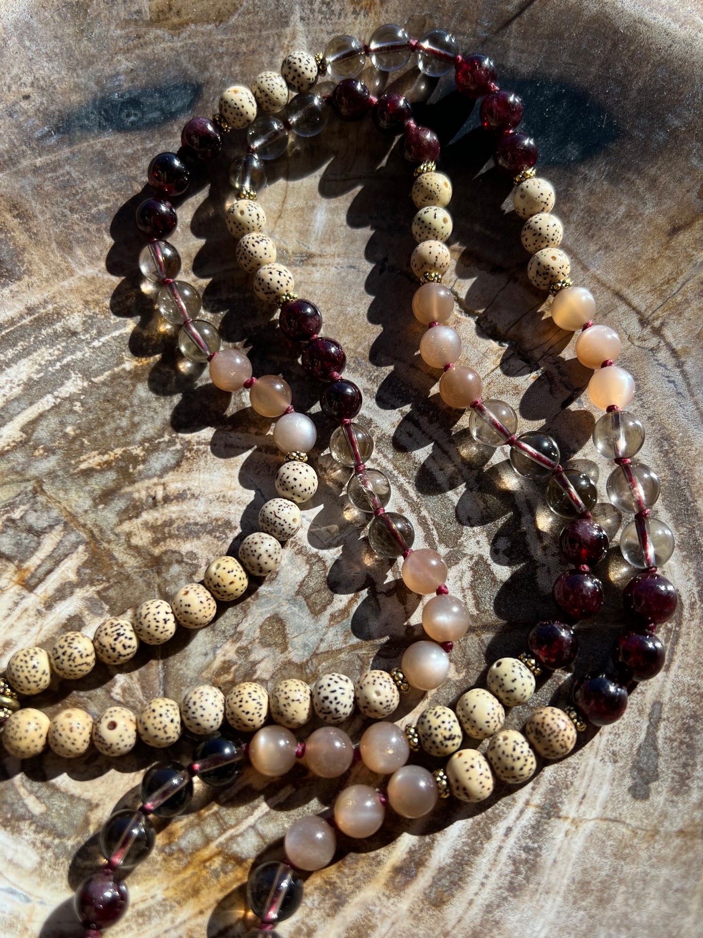 Mālā with Garnet, Smoky Quartz, Sunstone and Lotus Seed Beads with a Carved Lotus Guru Bead/ Pendant