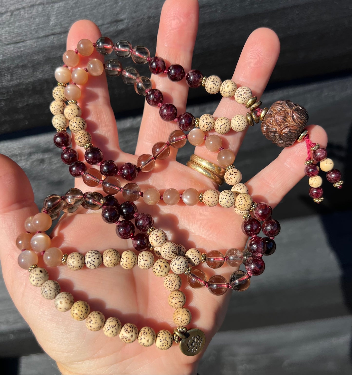 Mālā with Garnet, Smoky Quartz, Sunstone and Lotus Seed Beads with a Carved Lotus Guru Bead/ Pendant