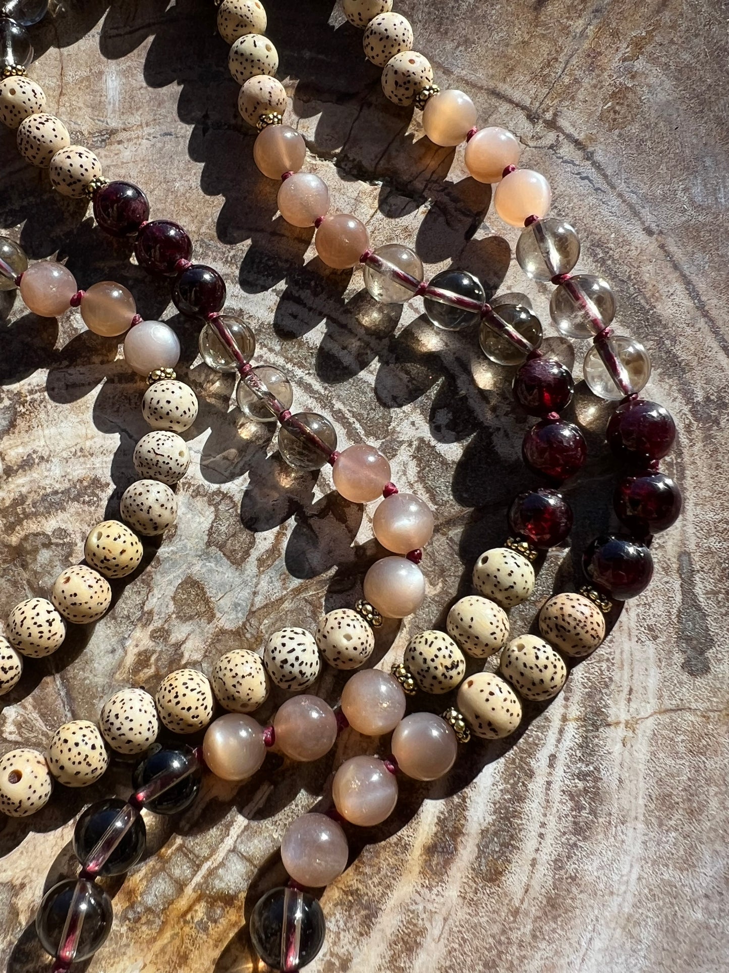 Mālā with Garnet, Smoky Quartz, Sunstone and Lotus Seed Beads with a Carved Lotus Guru Bead/ Pendant