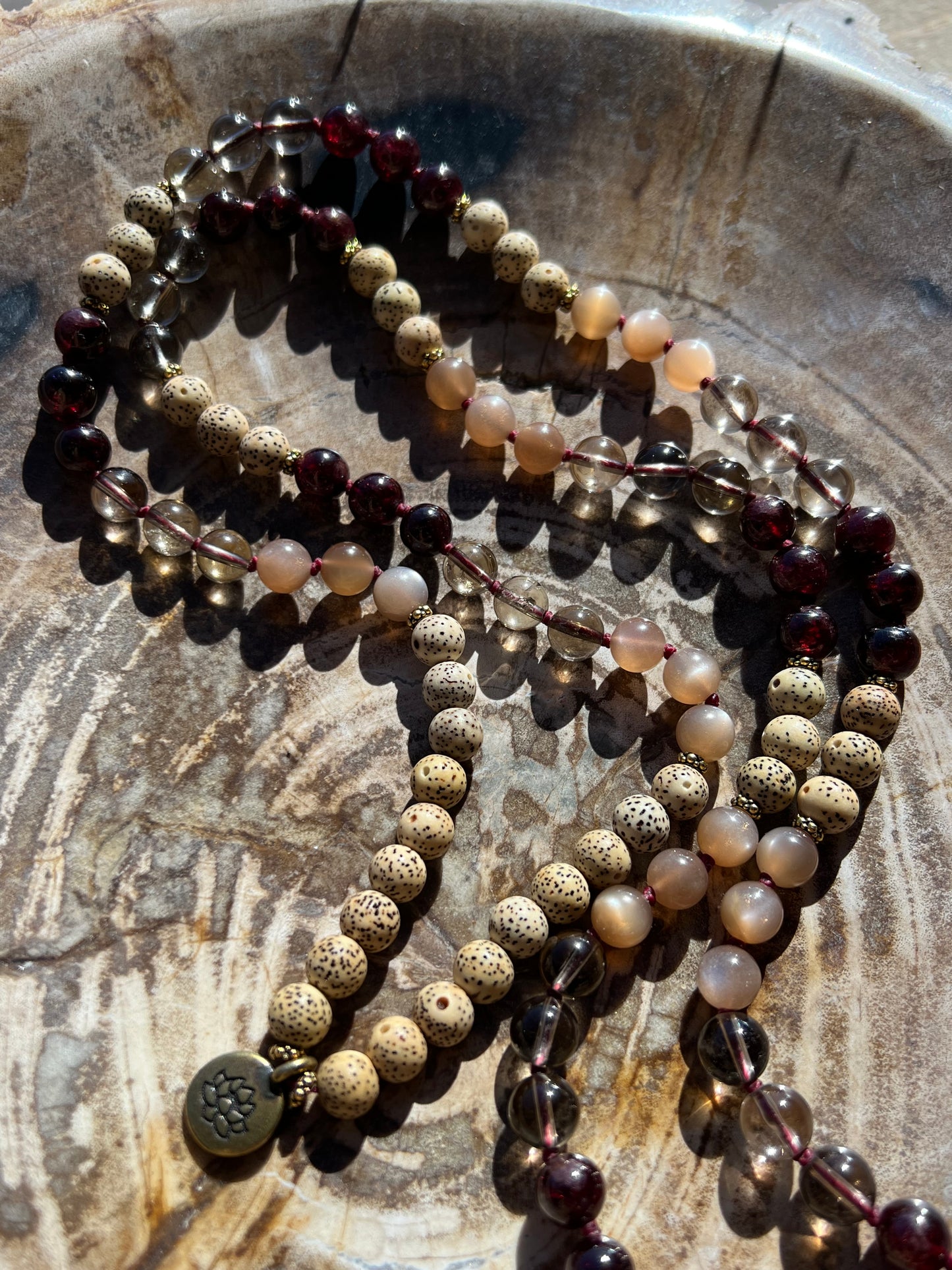 Mālā with Garnet, Smoky Quartz, Sunstone and Lotus Seed Beads with a Carved Lotus Guru Bead/ Pendant